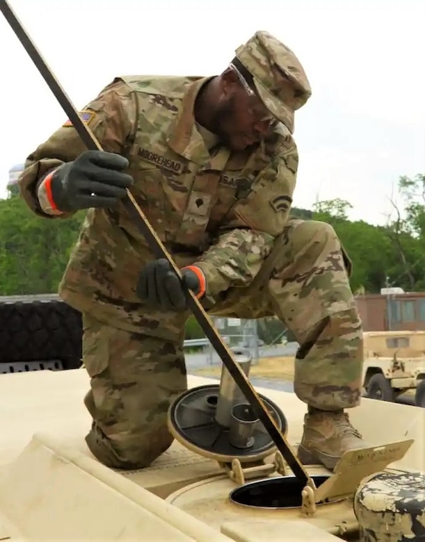 Spc. Simeon Moorehead of the New York National Guard's 42nd Infantry Division conducts maintenance on a vehicle June 11, 2023, during a Warfighter exercise at Fort Indiantown Gap, Pa. (U.S. Army National Guard photo by Staff Sgt. Andrew Valenza)