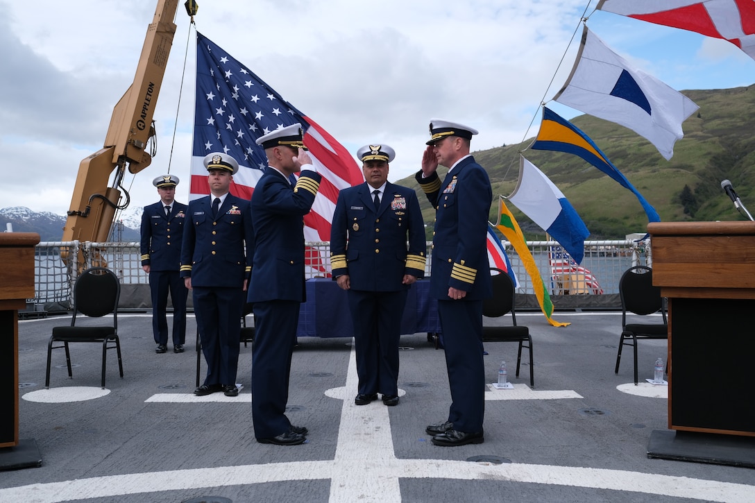 U.S. Coast Guard Capt. Timothy Brown and Capt. Billy Mees salute one another during the Coast Guard Cutter Bertholf's change of command ceremony in Kodiak, Alaska, June 12, 2023. Mees relieved Brown as the Bertholf's newest commanding officer. (U.S. Coast Guard photo by Chief Petty Officer Oliver Fernander)