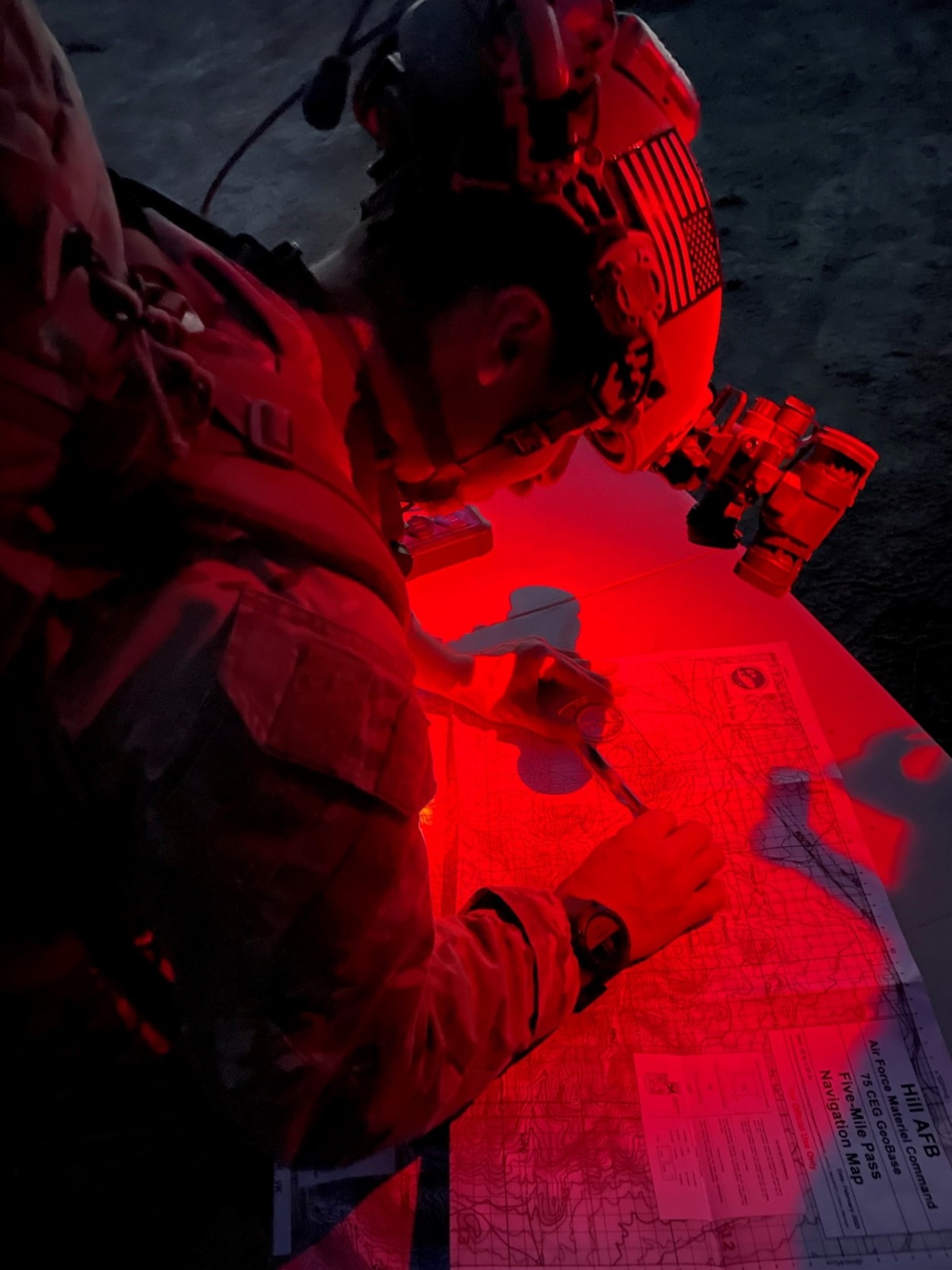 Senior Airman Marc Friedman, EOD team member from the 775th Civil Engineer Squadron, plans a route during a nighttime land navigation operation. During a week-long event, EOD technicians ran 28 training events across the spectrum of EOD’s wartime missions. (U.S. Air Force photo by Capt. James Stapleton)