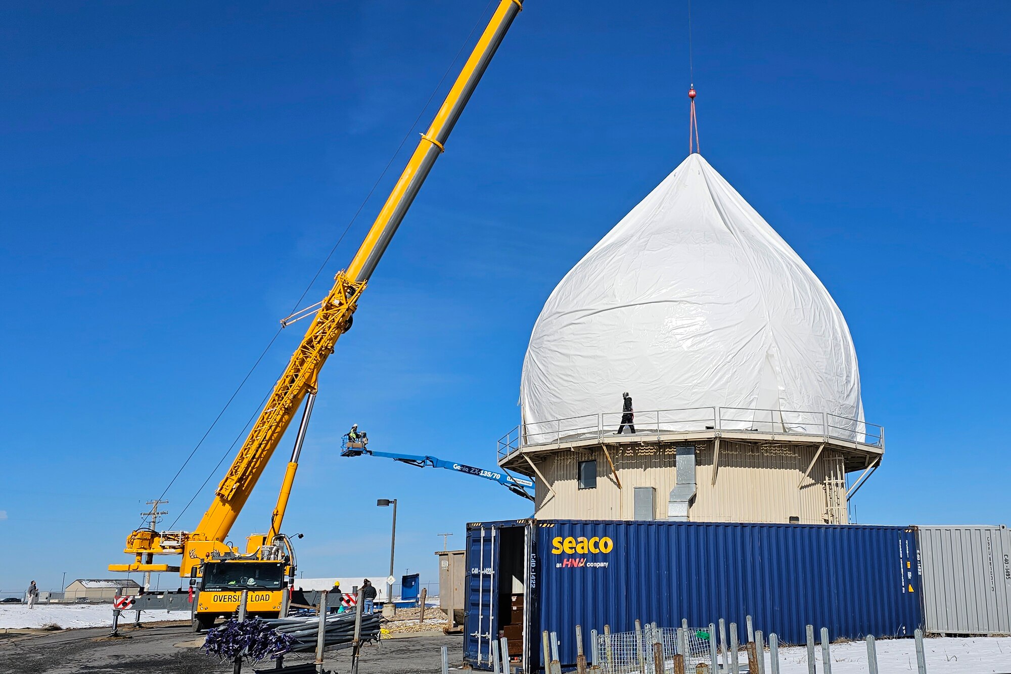Crews deploy a newly developed temporary inflatable work enclosure over a radome structure in December 2022 at Hill Air Force Base, Utah, which can protect workers from inclement weather when doing maintenance on the radome’s exterior panels. This radome structure is a test and engineering facility for the North American’s early warning radar defense system, known as the North Warning System. (Courtesy photo)