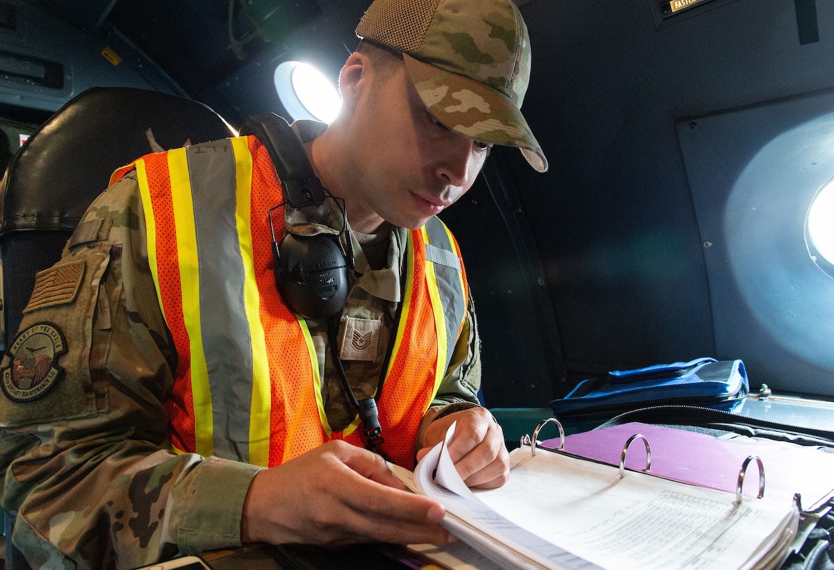 Tech. Sgt. Rendy Diaz Vargas, 436th Airlift Wing inspection team evaluator, reviews C-5M Super Galaxy aircraft forms prior to departing Dover Air Force Base, Delaware, June 6, 2023. Members of the 436th AW Inspector General office and wing inspection team evaluated the wing’s ability to safely generate and launch aircraft on time during a hurricane evacuation exercise. (U.S. Air Force photo by Roland Balik)