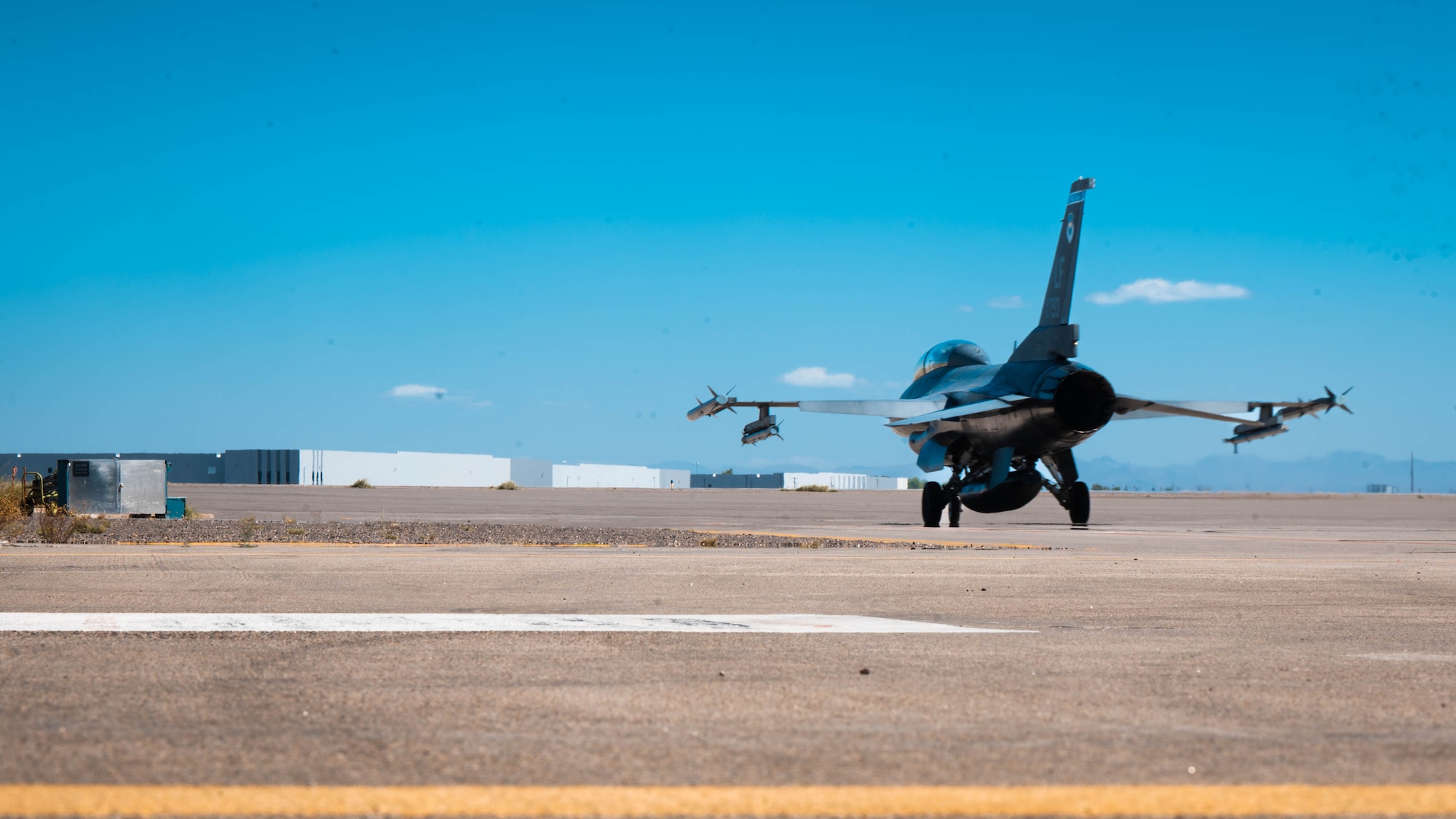 A U.S. Air Force F-16 Fighting Falcon taxis the runway of Luke Air Force Base