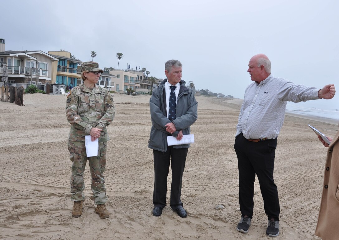 Director Matt Roberts, with Carpinteria Parks, Recreation and Public Facilities, right, discusses a CAP 103 study area May 23 along the shoreline with U.S. Army Corps of Engineers Los Angeles District commander Col. Julie Balten and supervisory civil engineer Charles Dwyer on Carpinteria Beach, California.  “The whole winter berm project was actually developed from a recommendation by the Army Corps of Engineers under FEMA that we do a programmatic response rather than an emergency response, so we began building the berm as a planned and permanent process,” Roberts said.