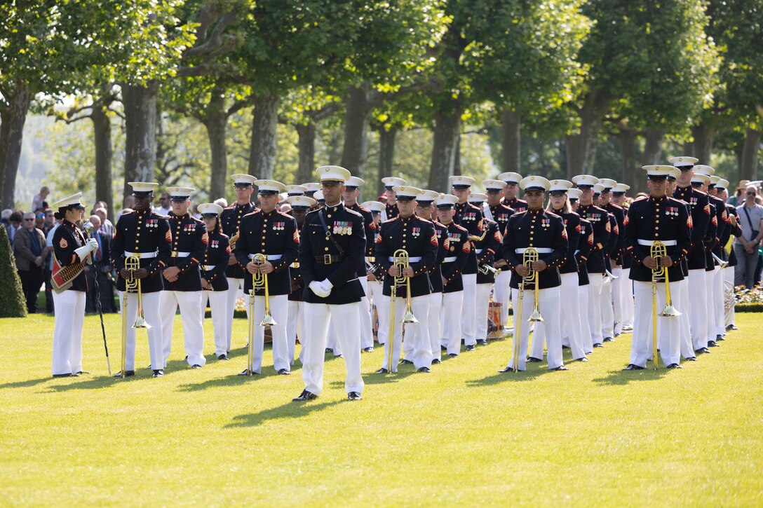U.S. Marines with the 1st Marine Division Band stand in formation during a ceremony at the Aisne-Marne American Cemetery and Memorial in Belleau, France, May 28, 2023. The ceremony was held to commemorate the 105th Anniversary of the Battle of Belleau Wood, honoring those service members who made the ultimate sacrifice for our freedom. American Battle Monument Commission staff throughout the world honor these fallen service members each and every day by maintaining memorial sites, offering commemoration services, and educating future generation of our nations fallen.