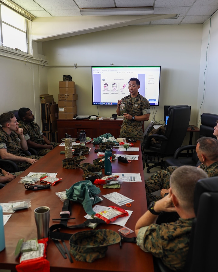 U.S. Navy Hospitalman 1st Class Marvin Gambito, center, a hosptial corpsman with 3rd Marine Expeditionary Brigade, III Marine Expeditionary Force, instructs Marines during Tactical Combat Casualty Care training aboard Camp Courtney, Okinawa, Japan, May 11, 2023. TCCC was developed by the U.S. Department of Defense Defense Health Agency (DHA) Joint Trauma System to teach  evidence-based, life-saving techniques and strategies for providing the best trauma care on the battlefield. (U.S. Marine Corps photo by Staff Sgt. Andrew Ochoa)