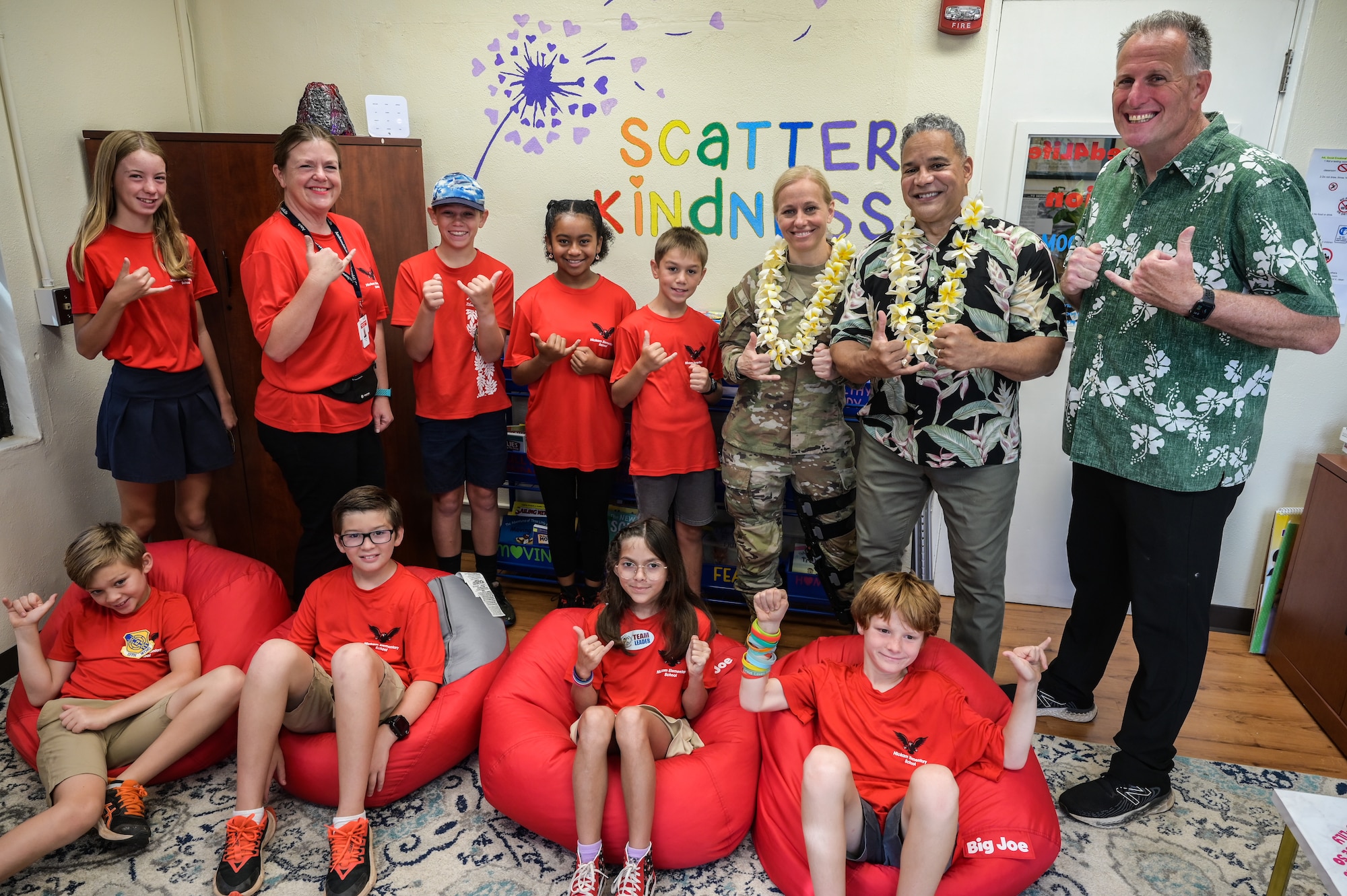 Resiliency team volunteers from the Lt. Col. Horace Meek Hickam Elementary School, Col. Michele Lo Bianco, 15th Wing commander, and Dr. John Duarte, 15th Wing prevention coordinator, pose for a photo in a resiliency room at Hickam Elementary on Joint Base Pearl Harbor-Hickam, Hawaii, May 31, 2023. The school is home to children whose parents serve in all branches within the Department of Defense, creating unique circumstances that come with being associated with the military. The room and garden are designed to address challenges that can vary from having a parent deployed, continuous moves and transitioning to new schools. (U.S. Air Force photo by Staff Sgt. Alan Ricker)