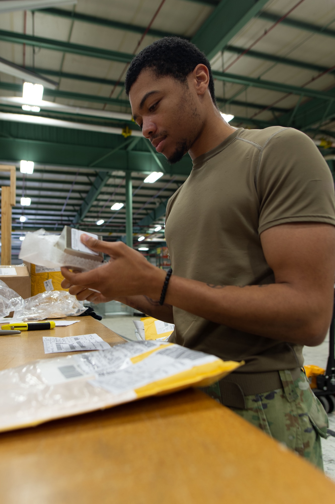 Senior Airman Jacob Wright, 436th Aerial Port Squadron inbound cargo specialist, checks an item against shipping documentation for correctness at Dover Air Force Base, Delaware, May 9, 2023. Packages arriving by commercial carriers are sorted by priority and shipping documents are validated against contents for correctness. (U.S. Air Force photo by Roland Balik)