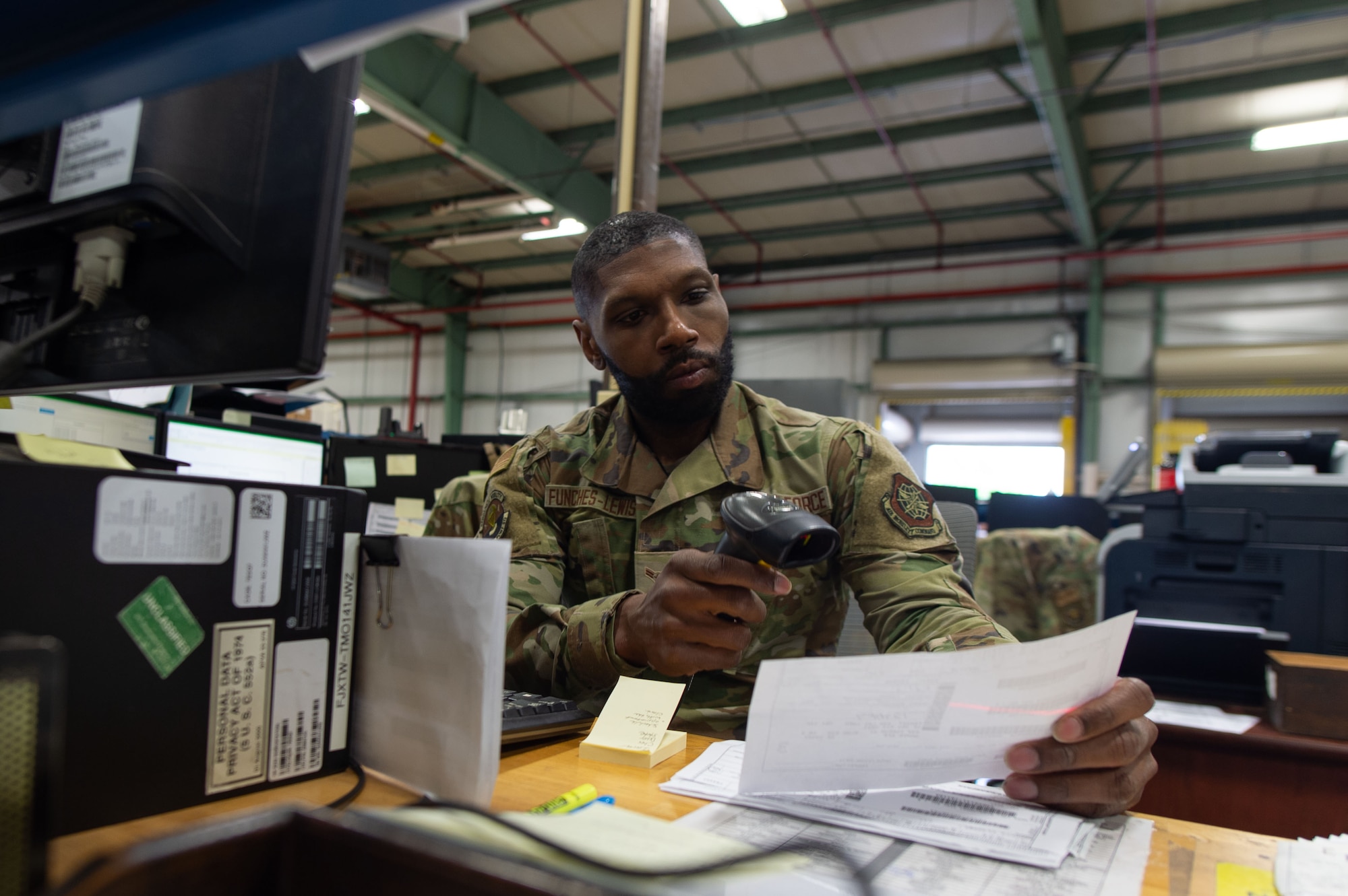 Airman 1st Class Dwoyne Funches-lewis, 436th Aerial Port Squadron inbound cargo specialist, scans shipping documentation at Dover Air Force Base, Delaware, May 9, 2023. Information is entered into a database prior to the last step of placing the item in a labeled bin designating the item as ready for pickup. (U.S. Air Force photo by Roland Balik)