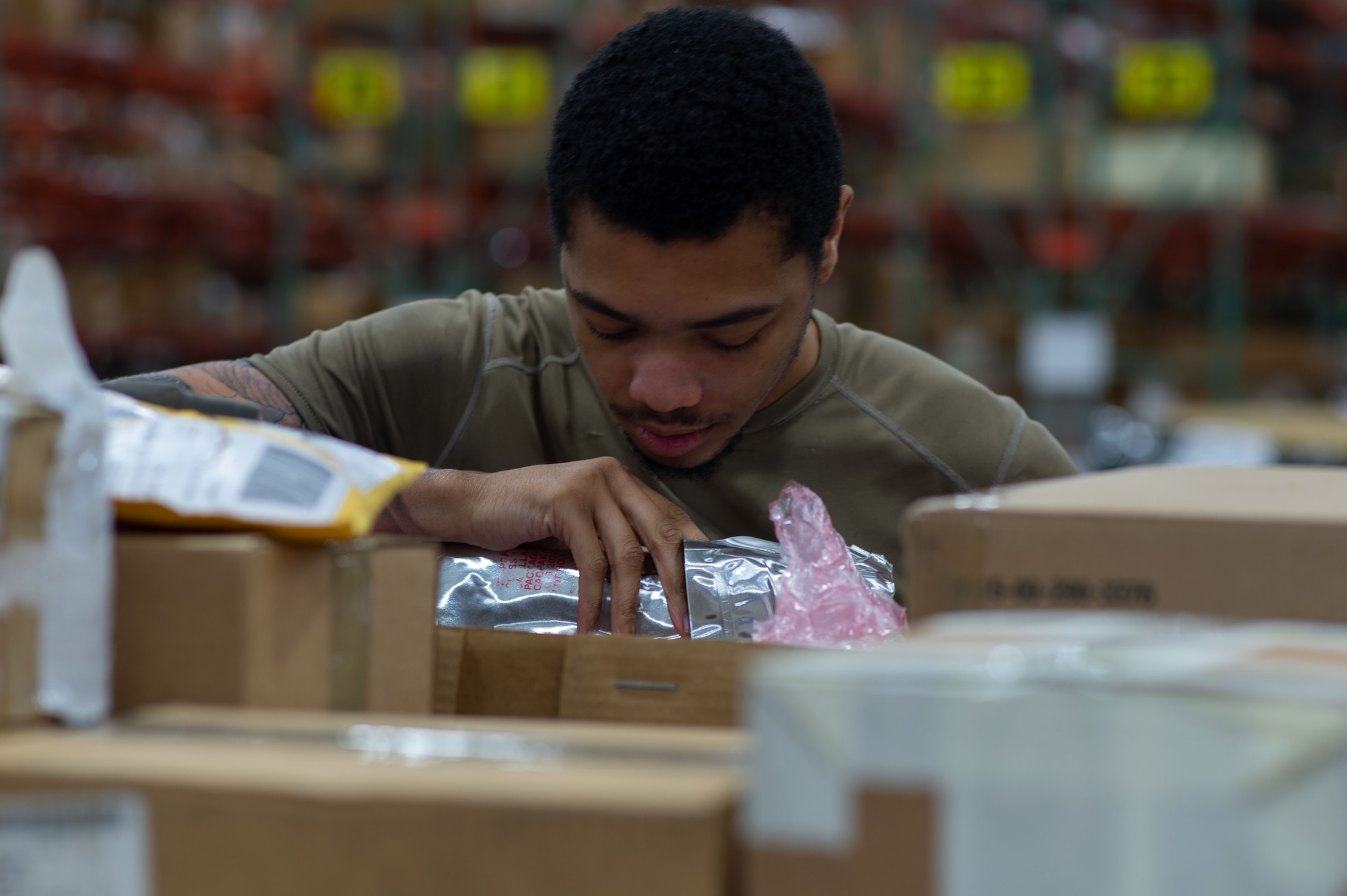 Senior Airman Jacob Wright, 436th Aerial Port Squadron inbound cargo specialist, checks the contents of a package delivered to Dover Air Force Base, Delaware, May 9, 2023. Packages arriving by commercial carriers are sorted by priority and shipping documents are validated against contents for correctness. (U.S. Air Force photo by Roland Balik)