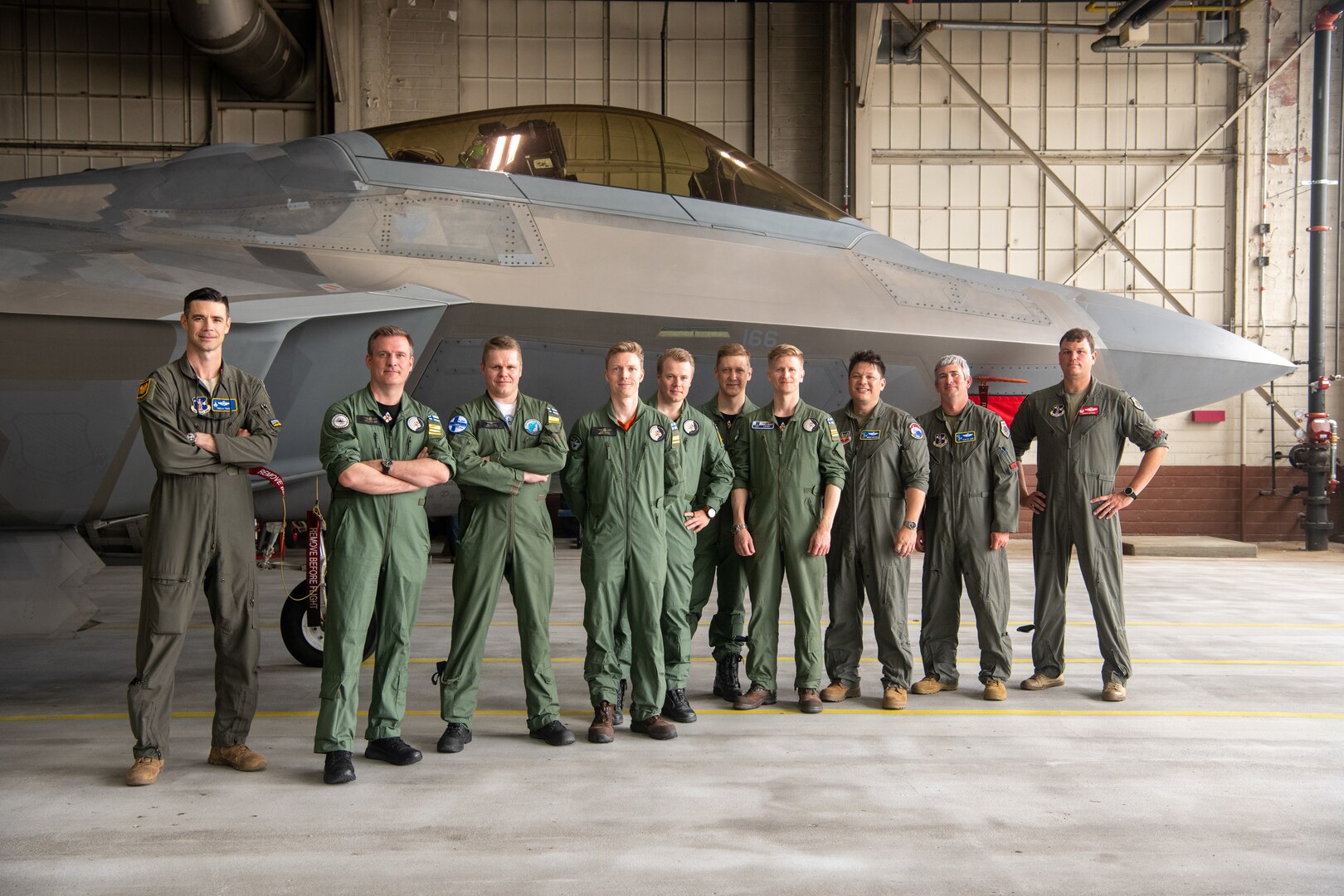 Group of pilots in front of F-22