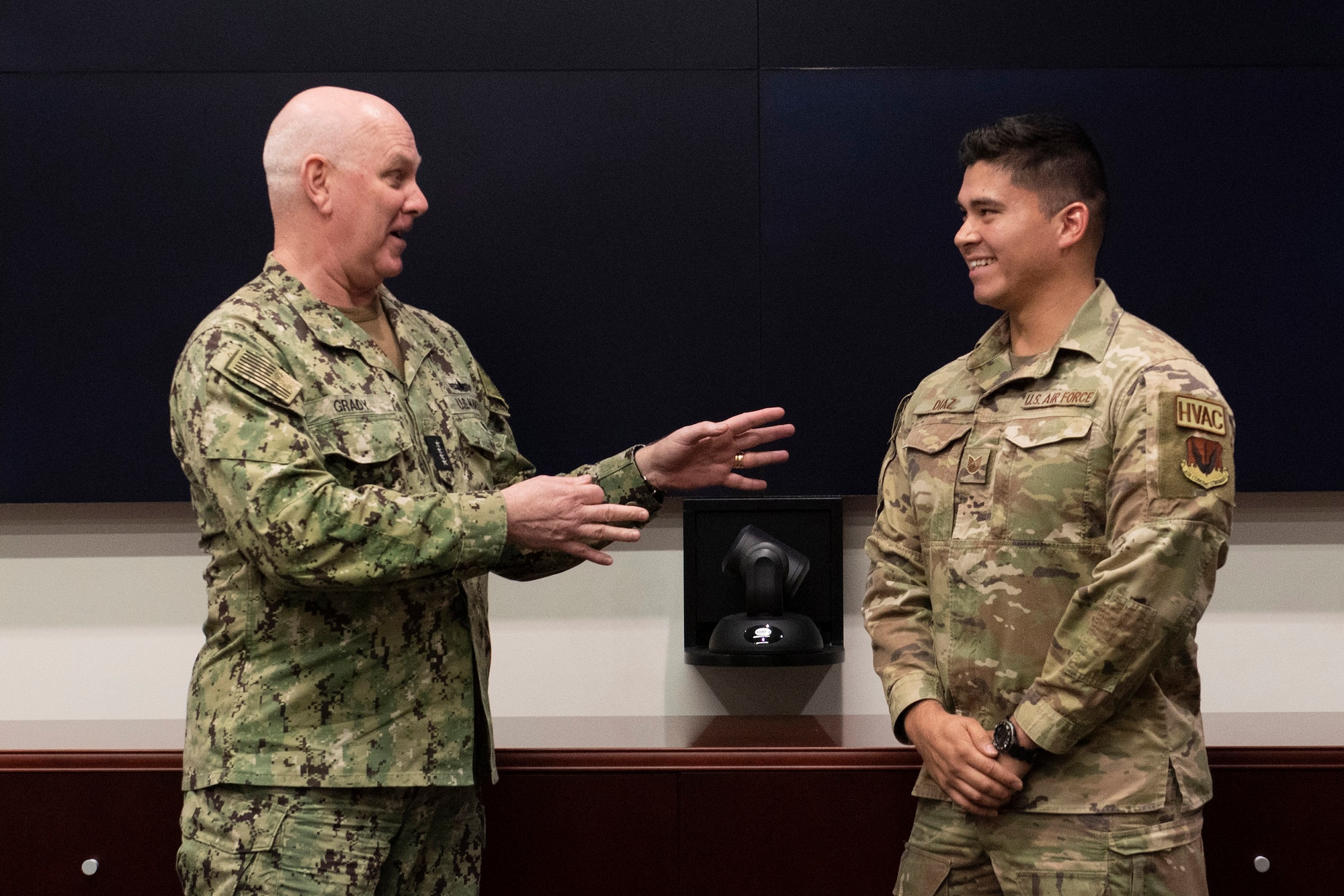 Admiral Christopher W. Grady (left), Vice Chairman of the Joint Chiefs of Staff, presents his military challenge coin to Air Force Tech. Sgt. Diego Diaz, an HVAC supervisor assigned to the Air Force Technical Applications Center’s 709th Support Squadron, Patrick Space Force Base, Fla.  The vice chairman visited the nuclear treaty monitoring center June 9, 2023 to learn more about how AFTAC delivers decisive advantage against enduring weapons of mass destruction threats and emerging weapon systems.  (U.S. Air Force photo by Matthew S. Jurgens)