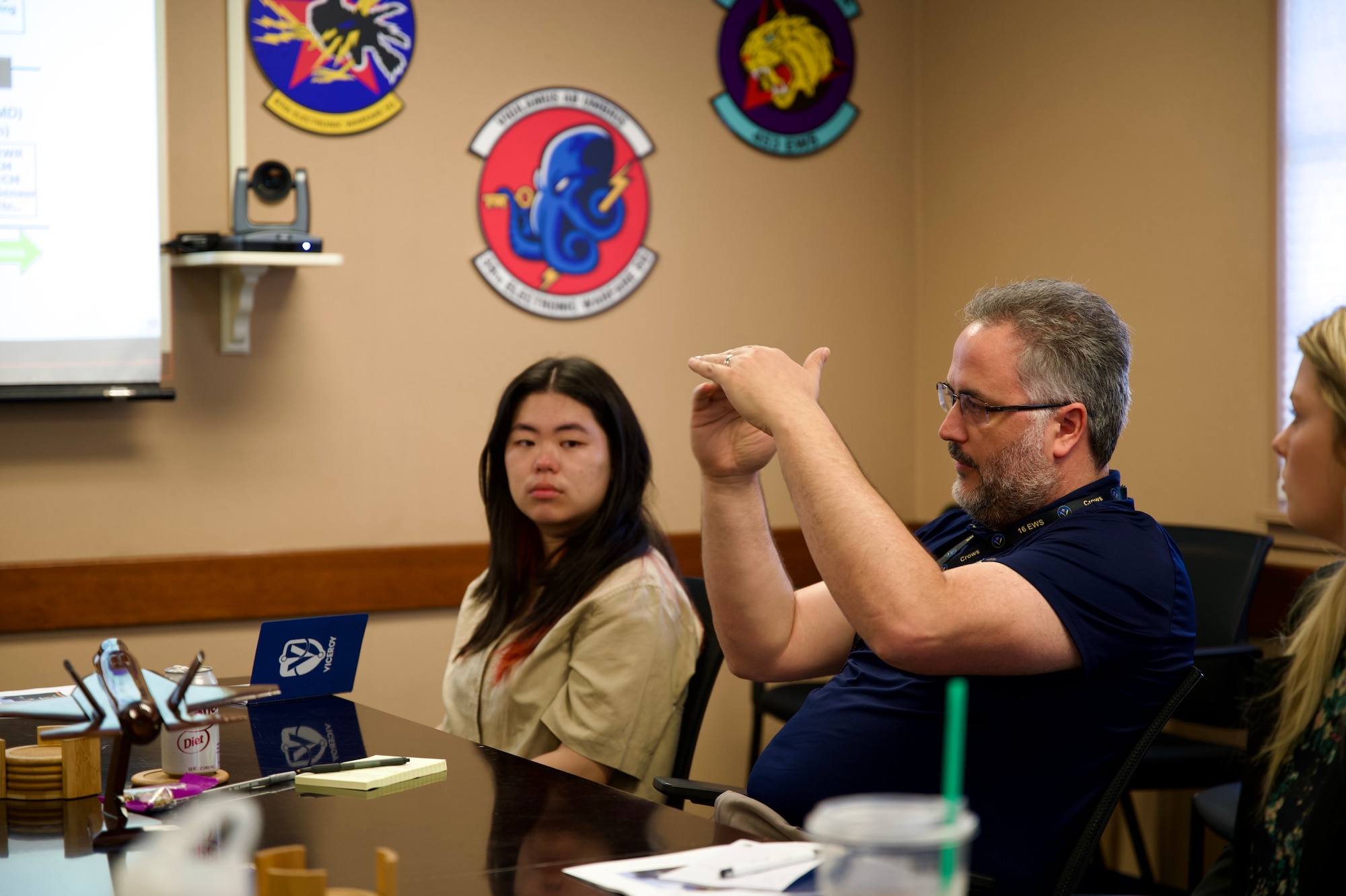 Michael Rafferty, 16th Electronic Warfare Squadron chief engineer, right, describes how mission data reprogramming works to a group of interns who will be interning at the 350th Spectrum Warfare Wing for the summer at Eglin Air Force Base, Fla., June 5, 2023. The Virtual Institutes for Cyber and
Electromagnetic Spectrum Research and Employ (VICEROY) Program allows for college students to work at DoD organizations to get hands on training and experience with critical missions to prepare them for a potential future career with the government. (U.S. Air Force photo by 1st Lt. Benjamin Aronson)