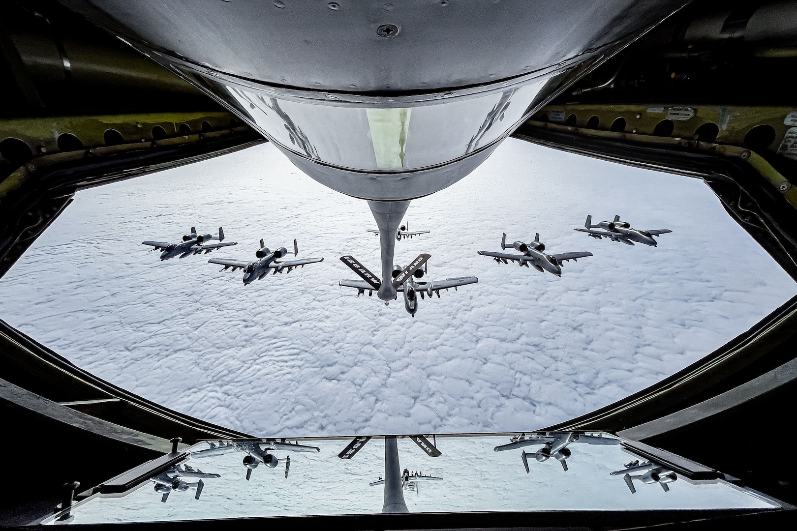 An Air Force A-10 Thunderbolt II aircraft flies in formation behind a KC-135 Stratotanker.