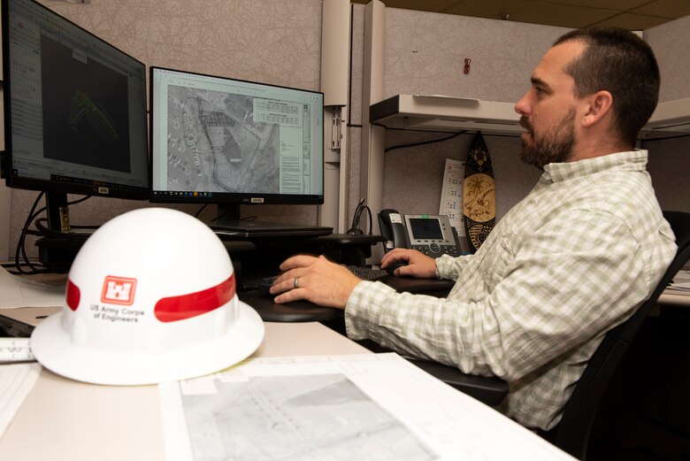 Brandon Whitley, civil engineer with the Civil Design Branch in Nashville, Tennessee, is the U.S. Army Corps of Engineers Nashville District Employee of the Month for April 2023. He is seen here June 13, 2023, looking at computer-aided design (CAD) files at his desk for the detention structure project in Cleveland, Tennessee. (USACE Photo by Lee Roberts)