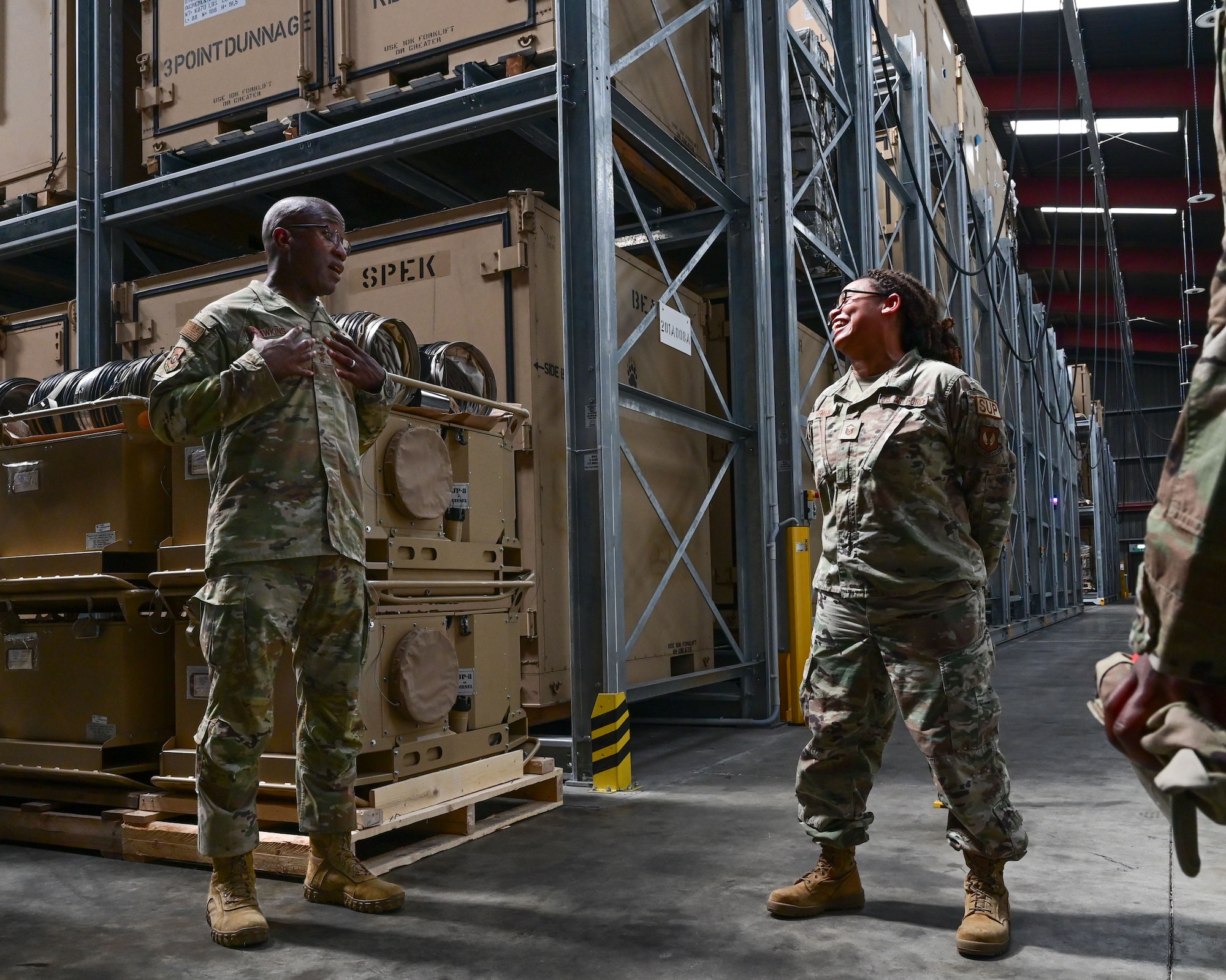 U.S. Air Force Lt. Gen. Stacey T. Hawkins, Air Force Sustainment Center commander, speaks with Master Sgt. Stephanie Green, 86th Materiel Maintenance Squadron materiel management flight chief, at Sanem, Luxembourg, June 8, 2023. Hawkins received mission briefs while touring the 86th MMS’ storage facilities to better understand their depot maintenance and supply chain management capabilities.  (U.S. Air Force photo by Senior Airman Andrew Bertain)