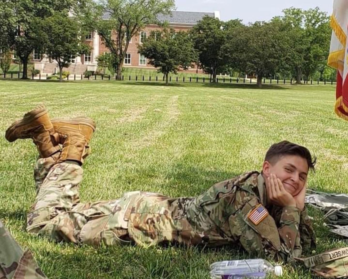 Female Soldier laying on grass in a field