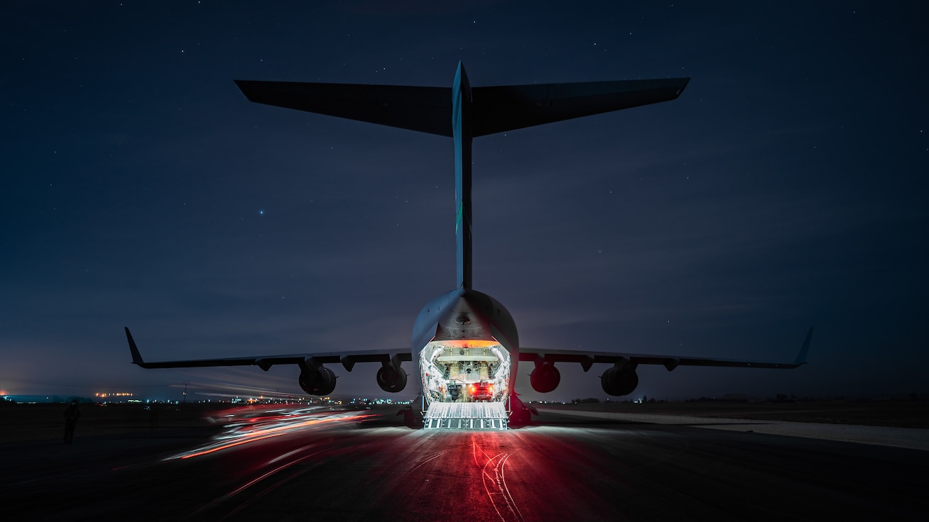 A U.S. Air Force C-17 Globemaster III crew assigned to the 8th Expeditionary Airlift Squadron unloads armored trucks during a Counter-ISIS Train and Equip Fund cargo supply mission in Syria, Jan. 11, 2023. CTEF is a funded program that provides Partner Forces with resources designed to assist in the enduring defeat of ISIS under Operation Inherent Resolve. (U.S. Army Reserve photo by Sgt. 1st Class Nicholas J. De La Pena)