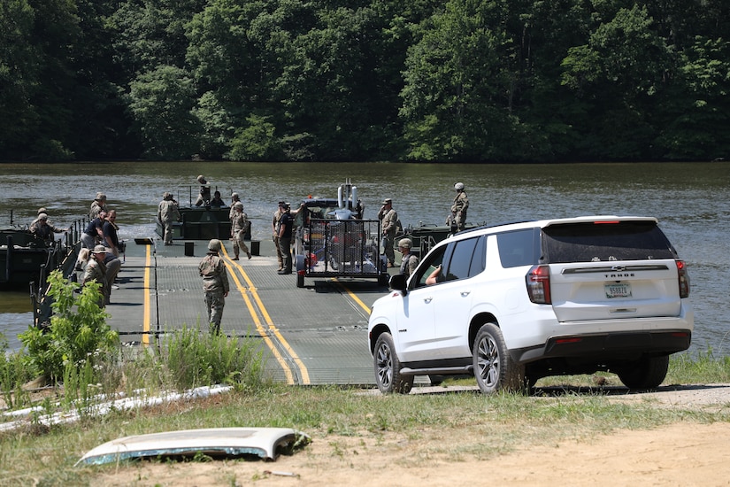 Soldiers from the Kentucky National Guard’s 2061st Multi-Role Bridge Company load vehicles onto their raft bridge