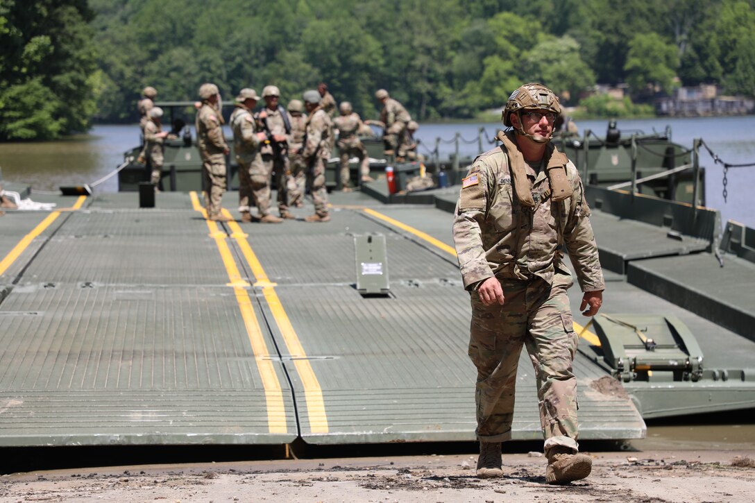 Staff Sgt. John Dennison, a platoon sergeant with the Kentucky National Guard’s 2061st Multi-Role Bridge Company, walks off the raft