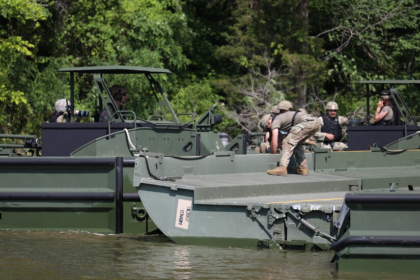 Soldiers from the Kentucky National Guard’s 2061st Multi-Role Bridge Company load vehicles onto their raft bridge to be transported to the other side of the lake during the Homeland Defender Exercise
