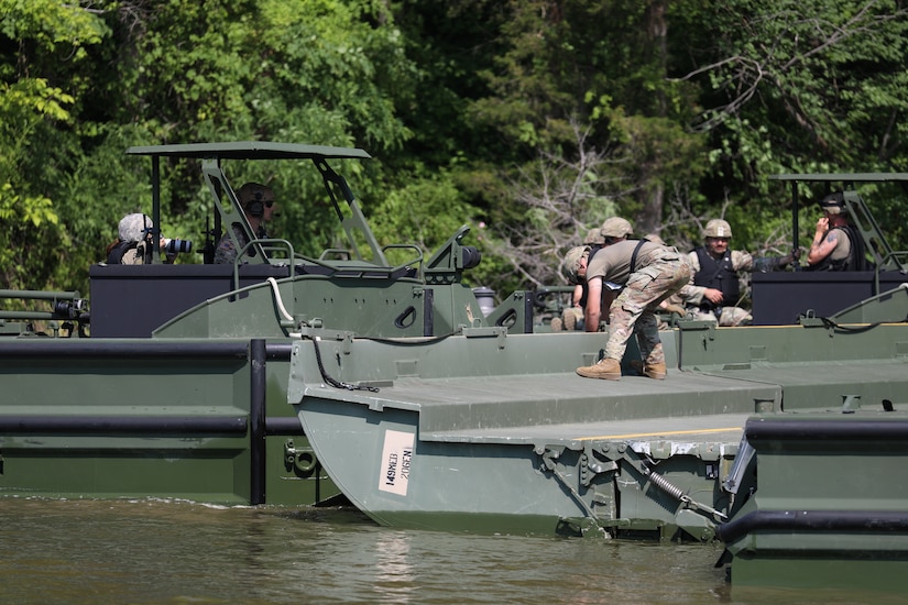 Soldiers from the Kentucky National Guard’s 2061st Multi-Role Bridge Company load vehicles onto their raft bridge to be transported to the other side of the lake during the Homeland Defender Exercise