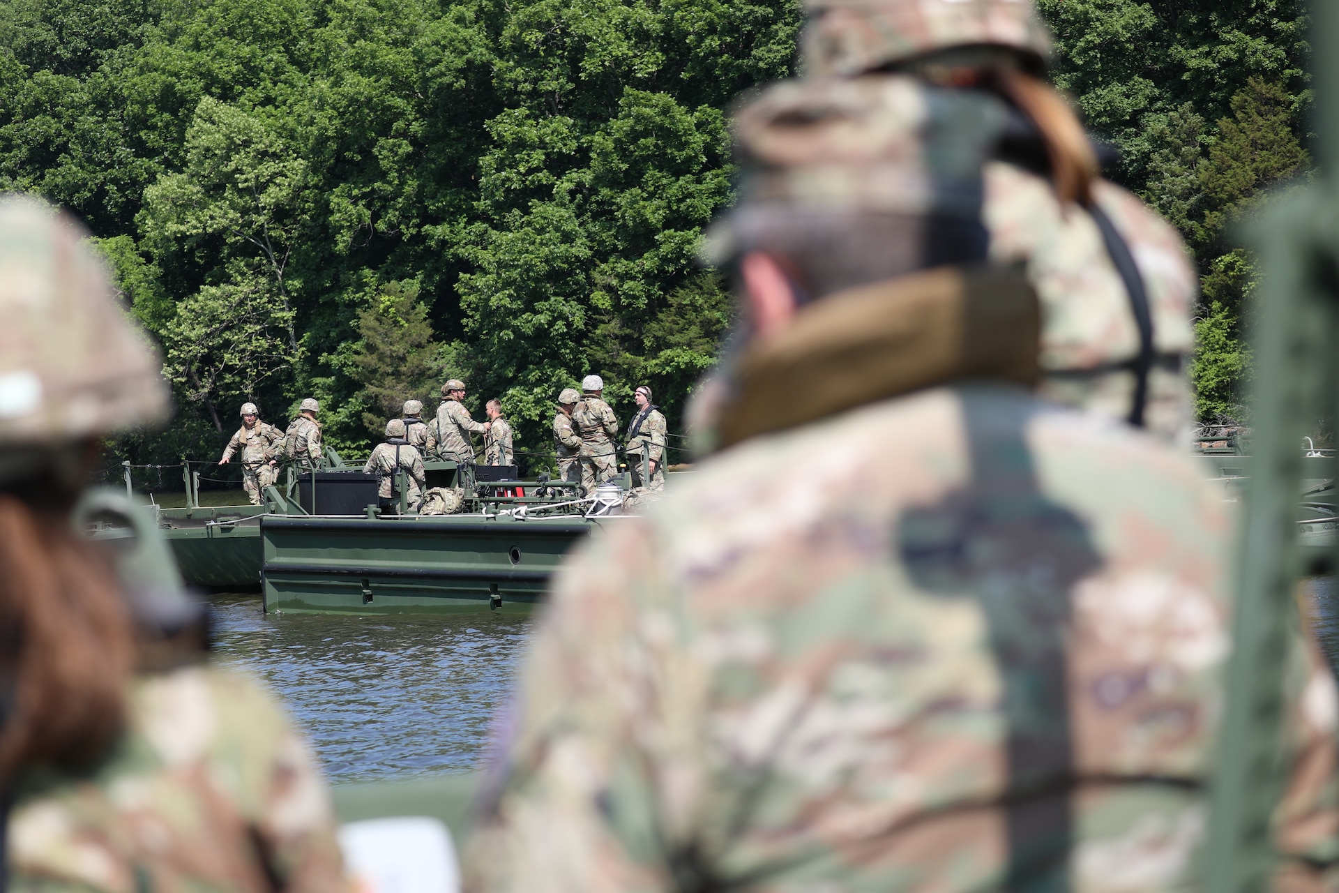 Soldiers from the Kentucky National Guard’s 2061st Multi-Role Bridge Company load vehicles onto their raft bridge to be transported to the other side of the lake during the Homeland Defender Exercise