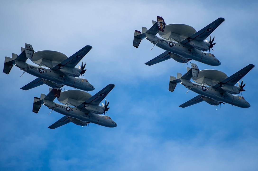 Four aircraft fly in formation.