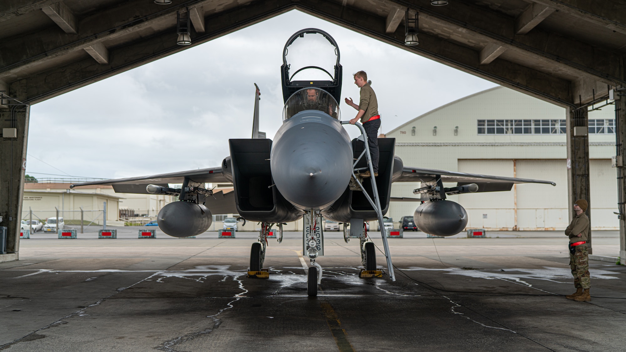 A U.S. Air Force pilot assigned to the 44th Fighter Squadron, left, and Airman 1st Class Gavin Tullier, 67th Aircraft Maintenance Unit crew chief, finalize preflight checks on an F-15C Eagle during a readiness exercise at Kadena Air Base, Japan, March 15, 2023. The 18th Wing is postured to respond to demanding scenarios, and continuously focuses on keeping forces ready for high-end missions through daily training and readiness exercises. (U.S. Air Force photo by Senior Airman Sebastian Romawac)