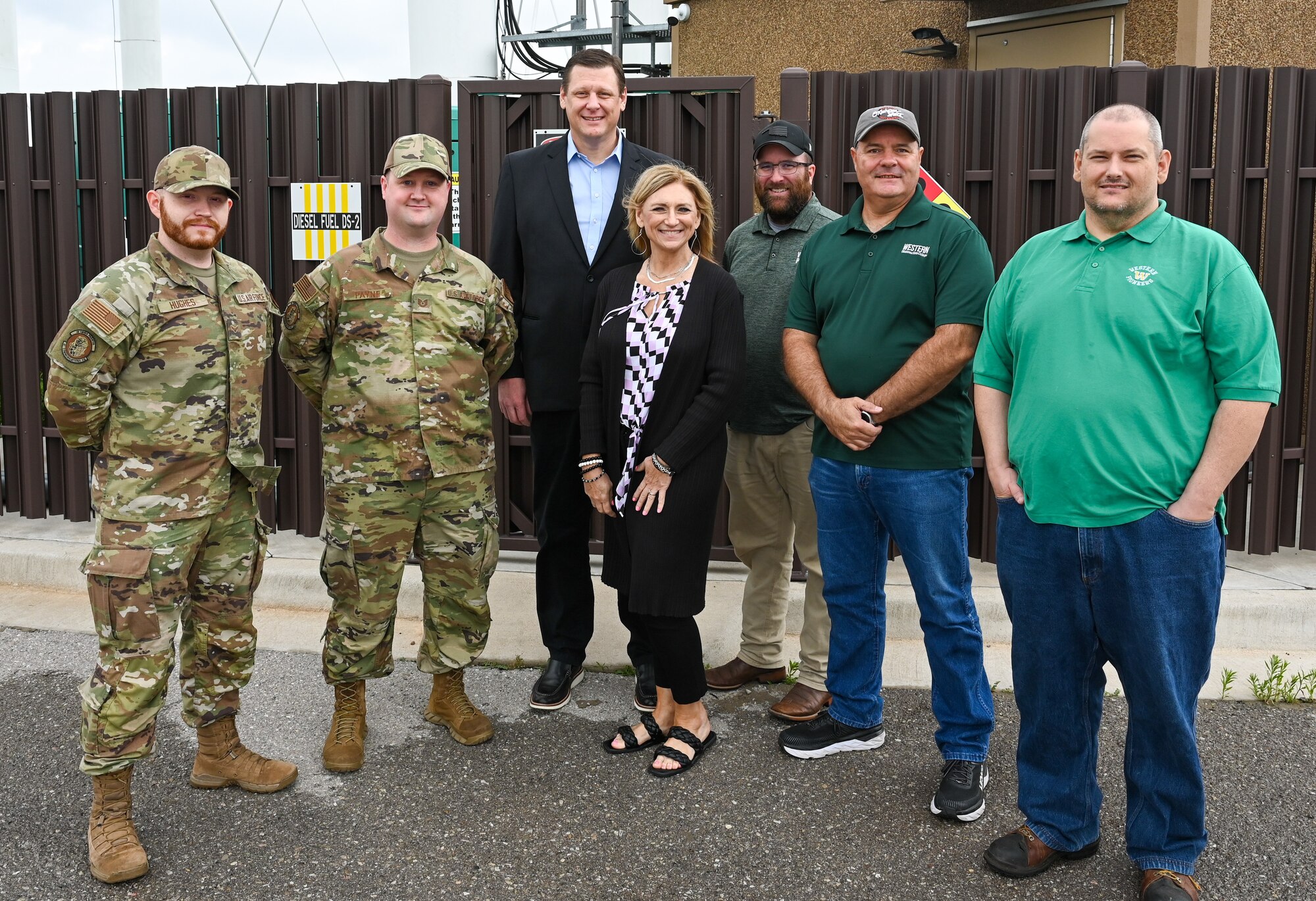 Chrystal Overton (center), 97th Communications Squadron (CS) honorary commander, and her team from Western Oklahoma State College (WOSC), pose for a photo with Airmen from the 97th CS at Altus Air Force Base, Oklahoma, June 12, 2023. Overton and her personnel learned about how the 97th CS employs technology as part of their mission on base. (U.S. Air Force photo by Airman 1st Class Heidi Bucins)