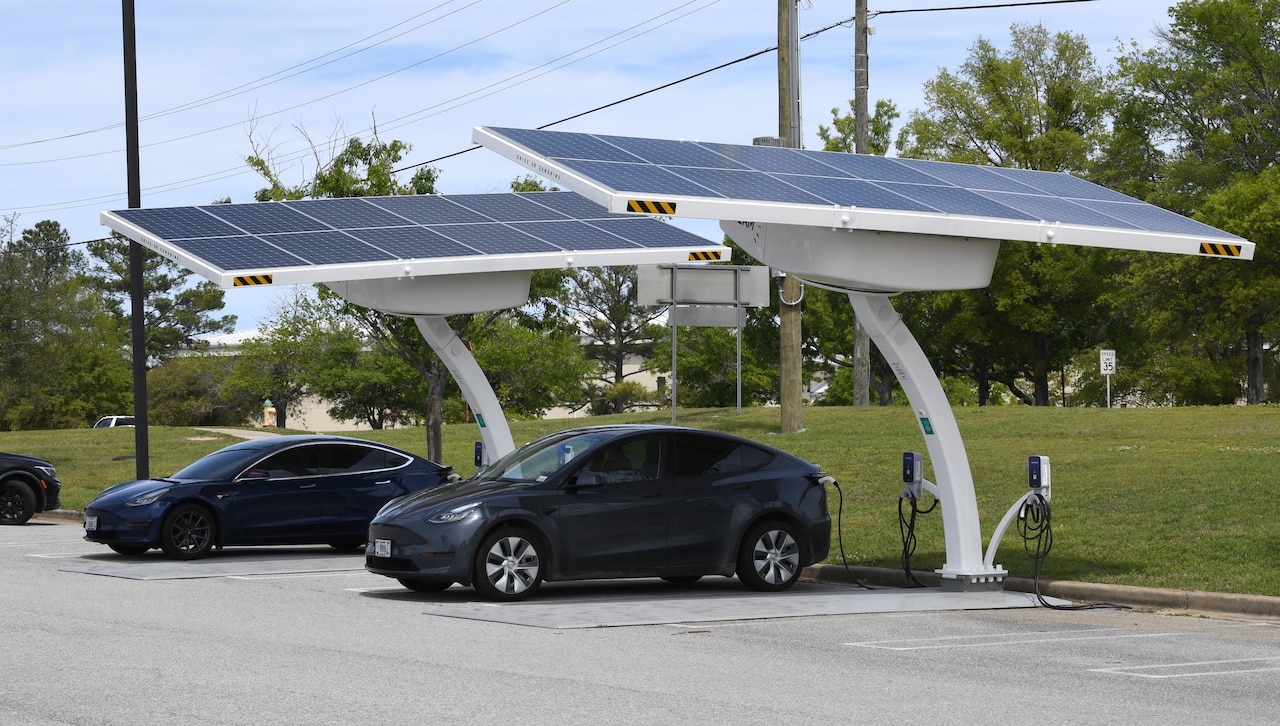 Electric vehicles charge at a solar-powered station.