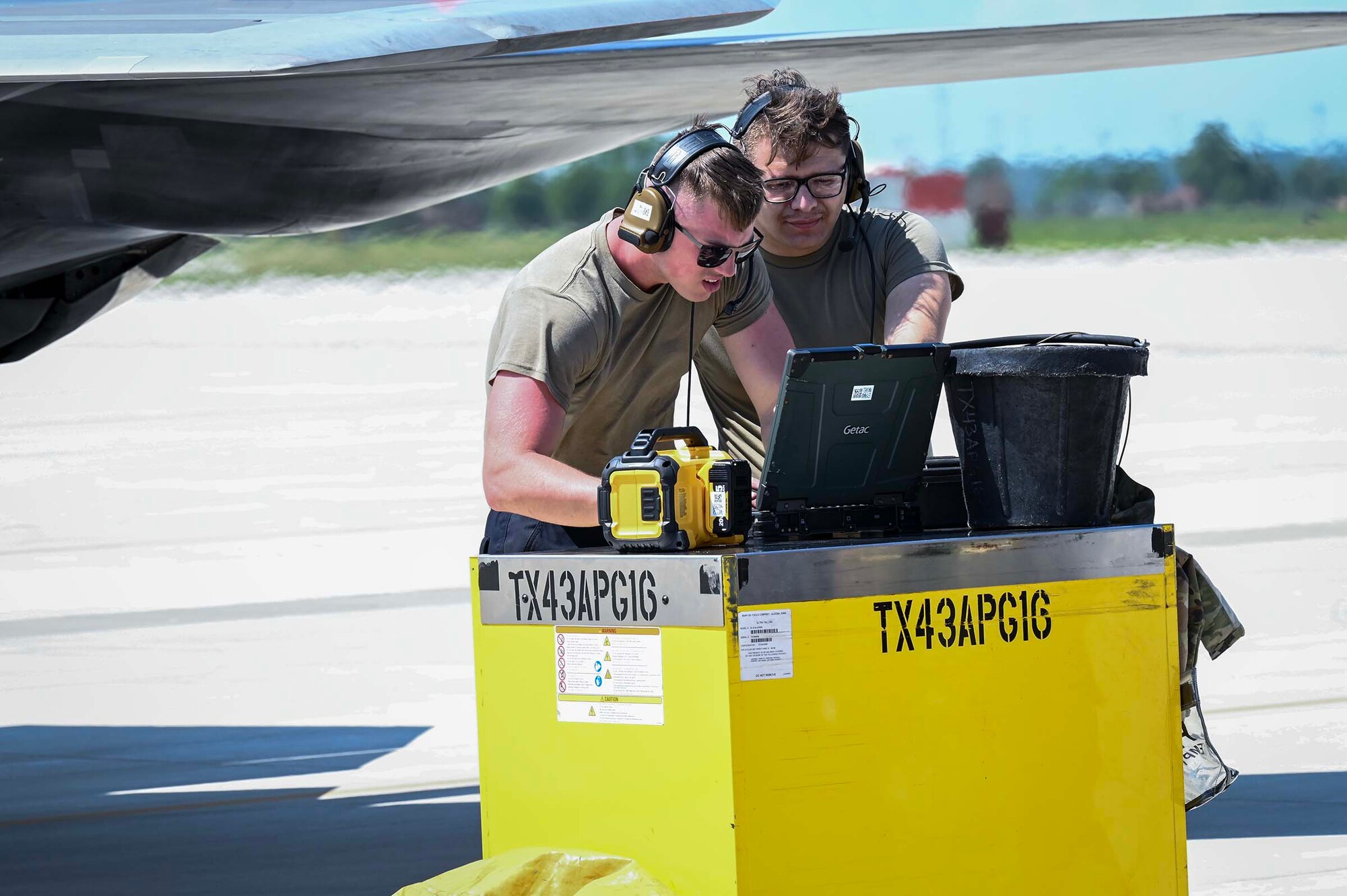 Maintainers discuss repairs.