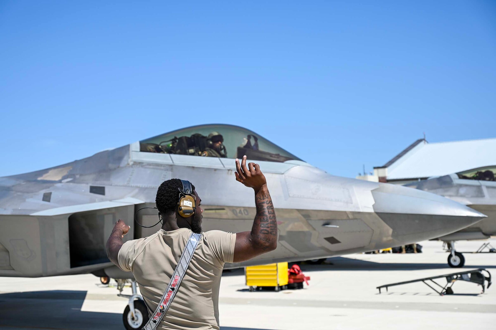 Maintainer marshals a jet.