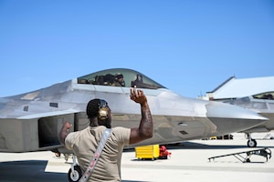 Maintainer marshals a jet.