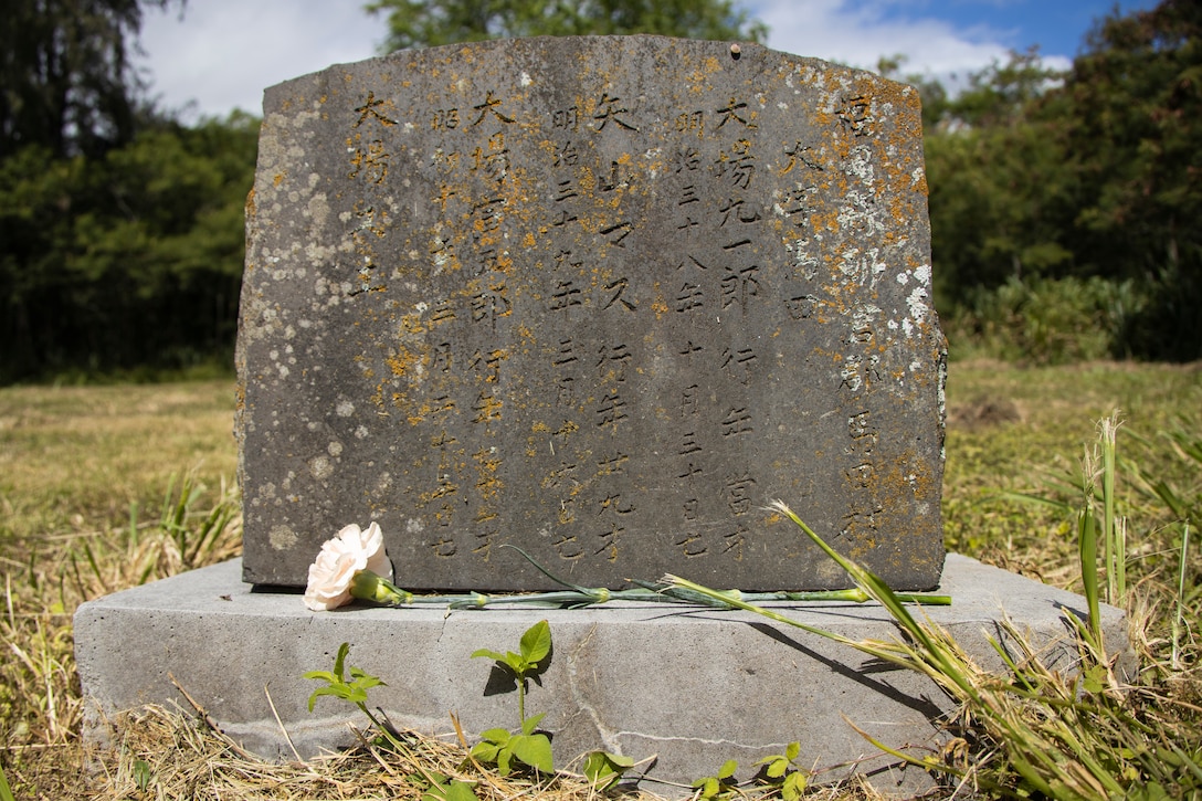 A flower rests upon an unmarked grave during Obon, a Buddhist memorial service, organized by Windward Buddhist Temple at Bellows Japanese Cemetery, Marine Corps Training Area Bellows, Marine Corps Base Marine Corps Base Hawaii, June 12, 2023. Members of the Windward Buddhist Temple honored the spirits of Japanese immigrants who worked at the Waimanalo Sugar Plantation as well as laborers from local dairy farms and members of the Waimanalo Hongwanji Temple and their descendants. (U.S. Marine Corps photo by Sgt. Julian Elliott-Drouin)