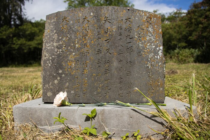 A flower rests upon an unmarked grave during Obon, a Buddhist memorial service, organized by Windward Buddhist Temple at Bellows Japanese Cemetery, Marine Corps Training Area Bellows, Marine Corps Base Marine Corps Base Hawaii, June 12, 2023. Members of the Windward Buddhist Temple honored the spirits of Japanese immigrants who worked at the Waimanalo Sugar Plantation as well as laborers from local dairy farms and members of the Waimanalo Hongwanji Temple and their descendants. (U.S. Marine Corps photo by Sgt. Julian Elliott-Drouin)