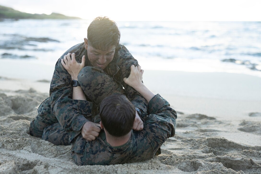 U.S. Marines grapple each other during a Marine Corps Martial Arts Instructor Course (MCMAIC) culminating event, Marine Corps Base Hawaii, June 9, 2023. The purpose of the MCMAIC culminating event was to challenge and test the course participants on both Marine Corp Martial Arts Program techniques and endurance before becoming a Marine Corps Martial Arts Instructor. (U.S. Marine Corps photos by Cpl. Chandler Stacy)