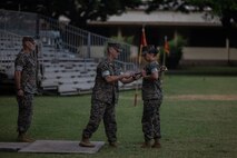 U.S. Marine Corps Sgt. Maj. Mayra Moreno, incoming sergeant major of Headquarters Battalion, Marine Corps Base Hawaii, receives the non-commissioned officer sword during a relief and appointment ceremony, MCBH, June 9, 2023. Sgt. Maj. Matthew Kidder relinquished his duties as sergeant major of HQBN, MCBH, to Moreno. (U.S. Marine Corps photo by Lance Cpl. Clayton Baker)