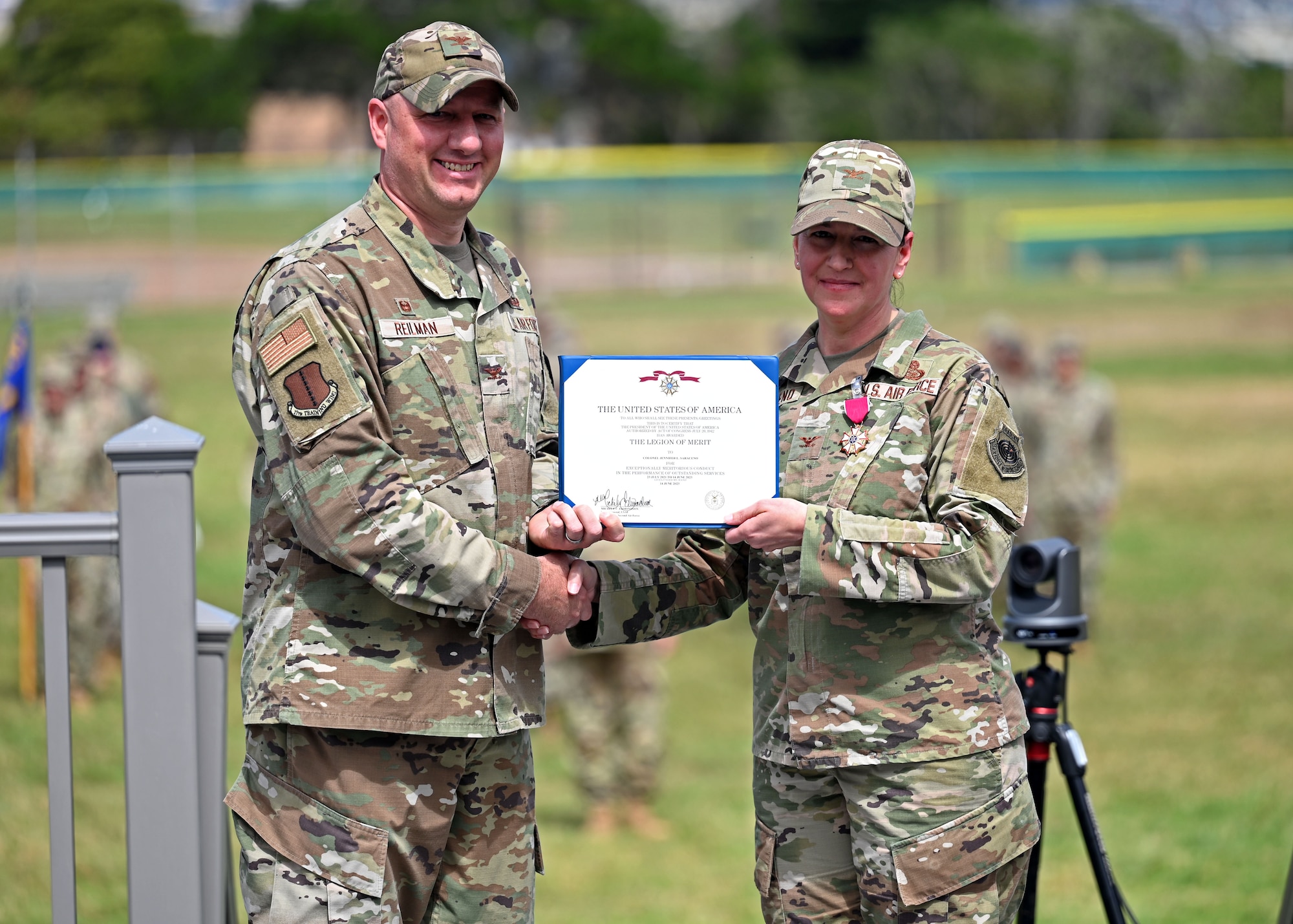 U.S. Air Force Col. Matthew Reilman, 17th Training Wing commander, presents the Legion of Merit award to the 517th Training Group outgoing commander, Col. Jennifer Saraceno, during the 517th TRG change of command ceremony on Soldier Field at the Presidio of Monterey, California, June 14, 2023. Saraceno served as the assistant commandant and the 517th TRG commander, directing language training for 34,000 Department of Defense personnel annually in more than 24 languages at 29 sites worldwide. (U.S. Air Force photo by Senior Airman Sarah Williams)
