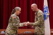 Joint Task Force-Red Hill (JTF-RH) Deputy Commander, U.S. Army Brig. Gen. Michelle Link, left, passes a piece of cake to JTF-RH Army element senior enlisted leader, Sgt. 1st Class Bruce Zolman, during  a ceremony to celebrate the 248th U.S. Army birthday at task force headquarters on Ford Island, Hawaii, June 14, 2023.