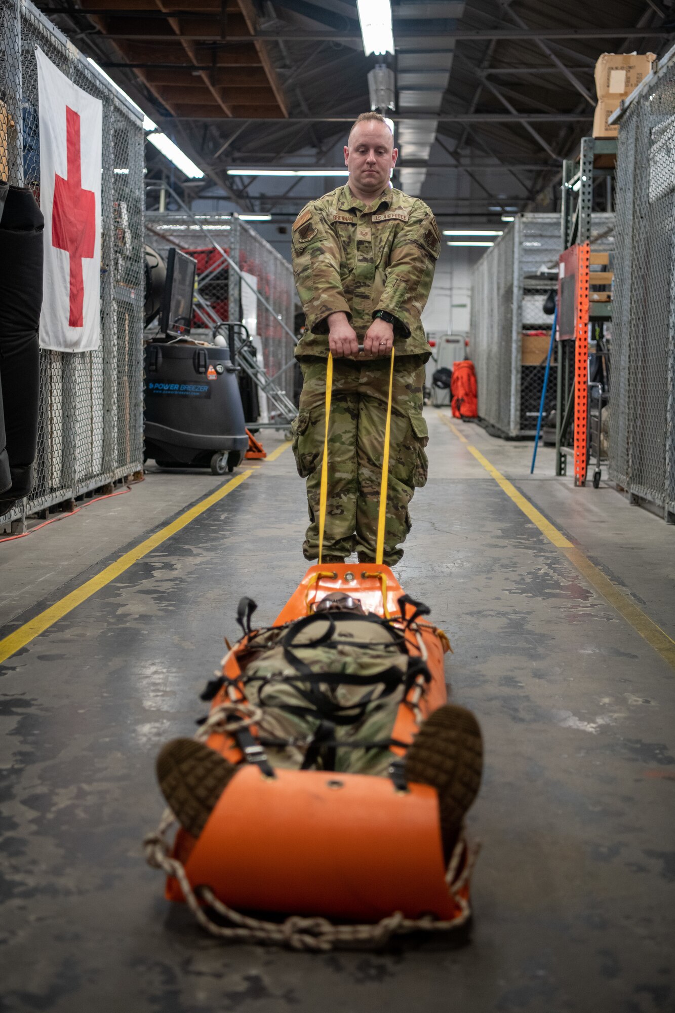 Airman pulling an Airman in a gurney