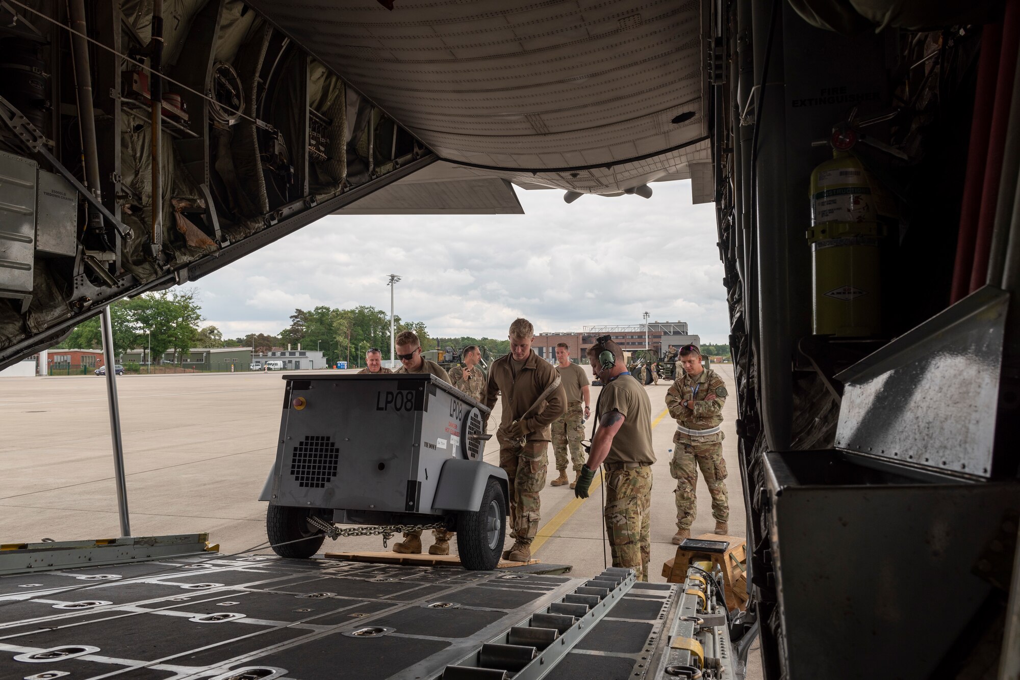 Airmen loading cargo onto aircraft.