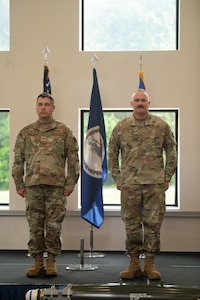 two people standing on stage