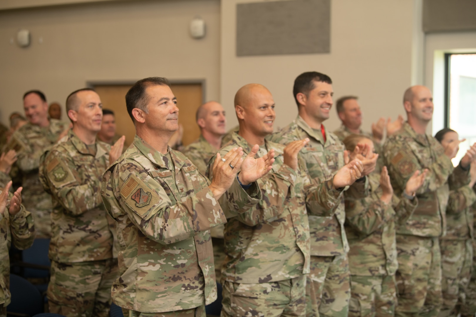 group of Airmen standing and applauding