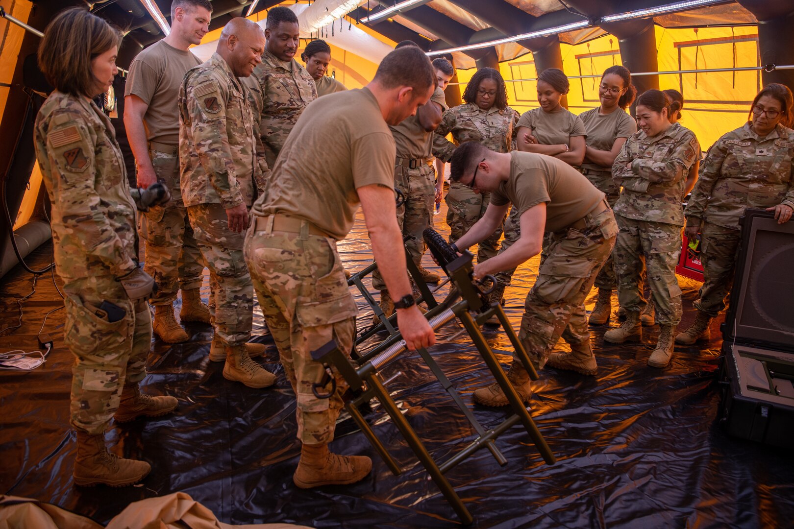 group of Airmen setting up medical transport gurney