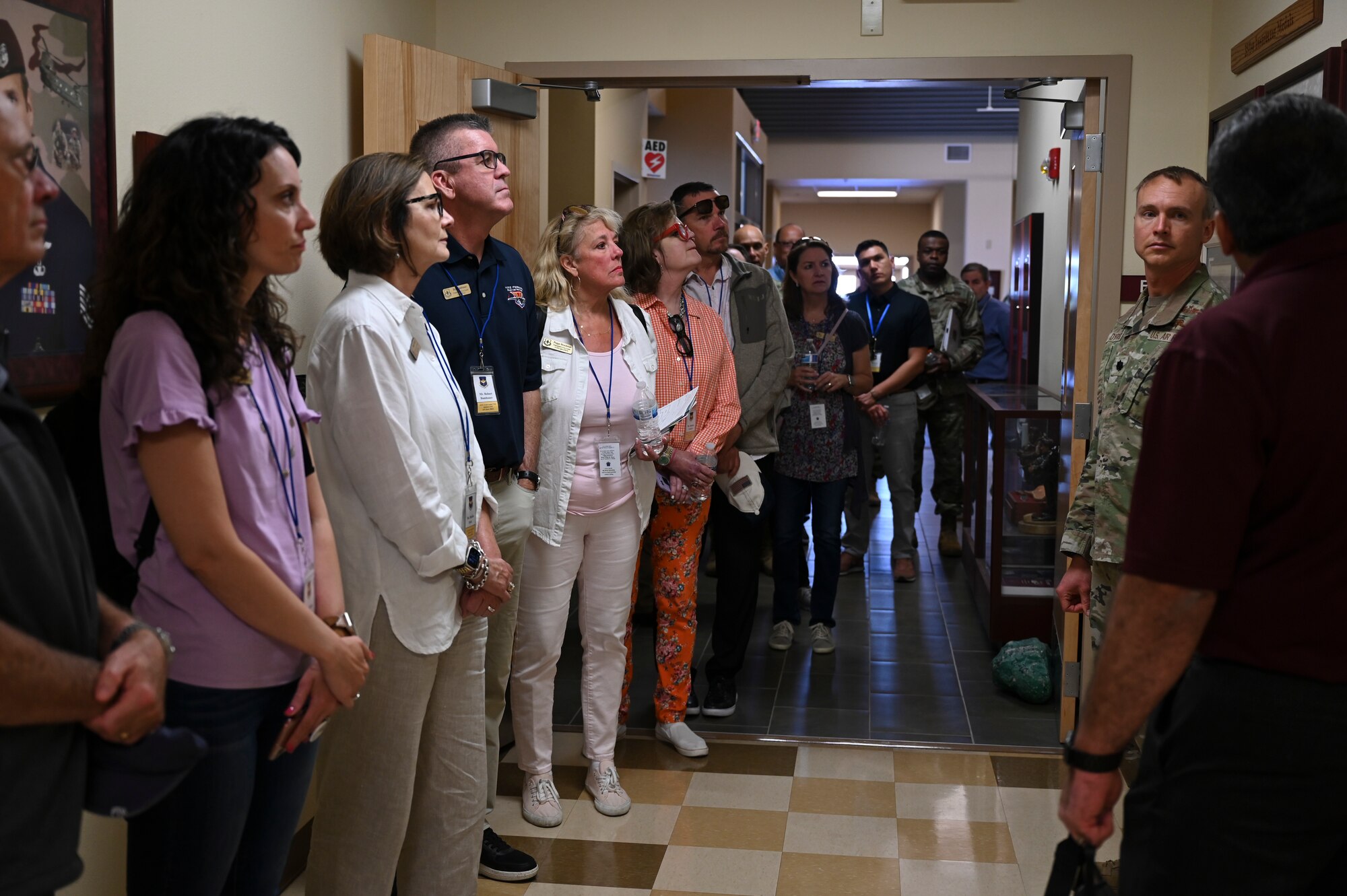 A group of people gather in a hall.