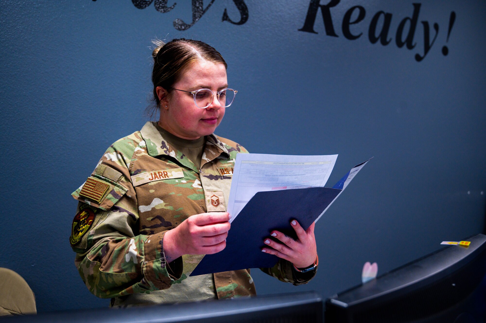 U.S. Air Force Master Sgt. Maria Jarr, 607th Air Control Squadron flight chief, reviews a file at her desk, May 18, 2023, at Luke Air Force Base, Arizona.