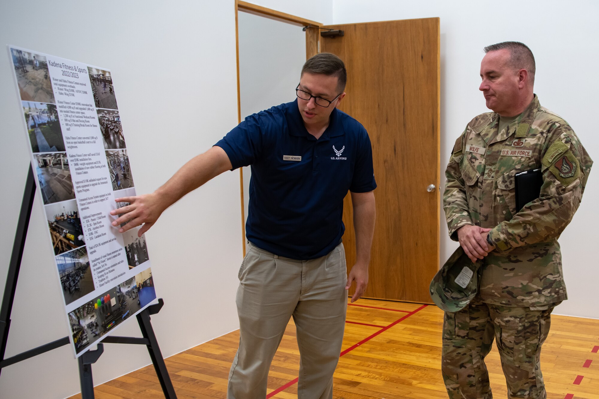 Two men look at an information board.