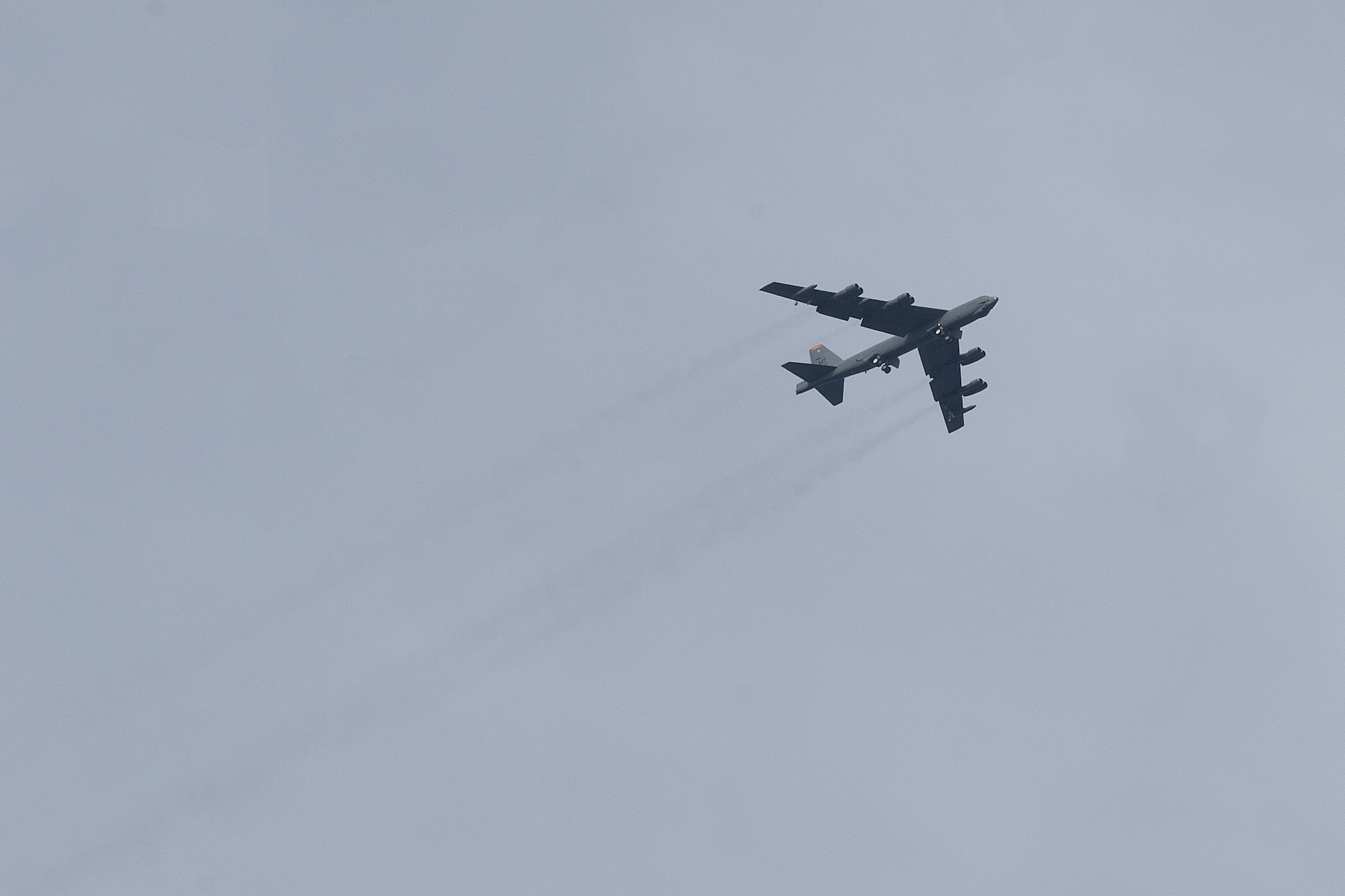 A U.S. Air Force B-52H Stratofortress assigned to the 23rd Bomb Squadron at Minot Air Force Base, North Dakota, soars over the flightline at Andersen Air Force Base, Guam, for a Bomber Task Force deployment, June 12, 2023. U.S. Strategic Command forces are on watch 24/7 globally, operating in all domains, while supporting other commands, to defend the nation and its allies. (U.S. Air Force photo by Tech. Sgt. Zade Vadnais)