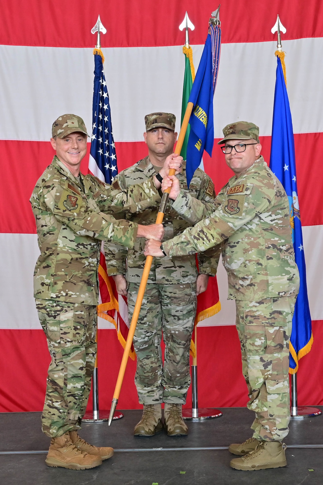 U.S. Air Force Brig. Gen. Tad Clark, 31st Fighter Wing commander, receives the guidon from U.S Air Force Col. Jason Mitchell, 31st Maintenance Group outgoing commander, to symbolize the changing of command at Aviano Air Base, Italy, June 15, 2023. The mission of the 31st Maintenance Group is to provide peacetime and combat maintenance and munitions control, and executive support for the 31st Fighter Wing, geographically separated units under the command and control of the wing, and units gained during advanced stages of readiness. (U.S. Air Force photo by Airman Zachary Jakel)