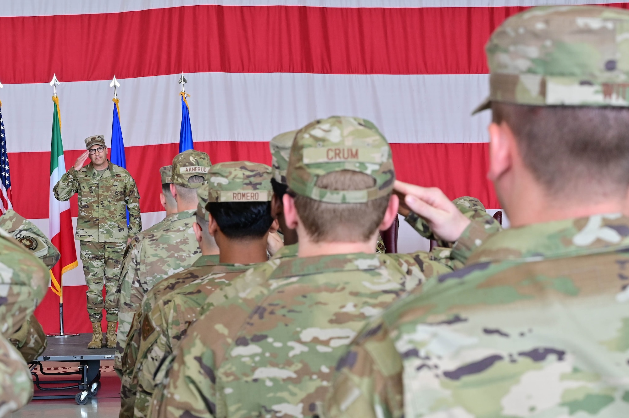 U.S. Air Force Col. Joe Stangl, 31st Maintenance Group incoming commander, renders his first salute to the group as their commander at Aviano Air Base, Italy, June 15, 2023. The 31st Maintenance Group responds to humanitarian and contingency logistics support requirements in Europe, Africa and Southwest Asia. (U.S. Air Force photo by Airman Zachary Jakel)